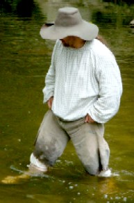 Michael wading, holding up his slops