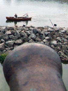 Michael & Kreiger in the boat in front of a cannon