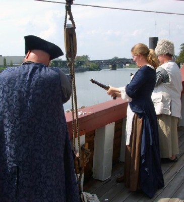 Kate prepares her pistol
