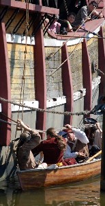 Pirates in the HMS Scow approach the Santa maria
