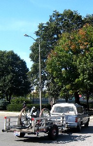 A cannon sitting on a trailer behind a truck