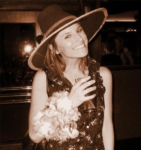 Girl in Patrick Hand hat with drink