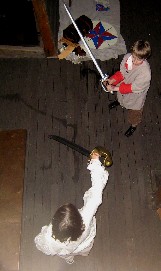 Ryan and Grace sword fight at night