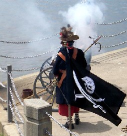 Captain John approaches his smoking cannon