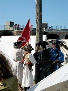 Pirates raising their flag over Fort Taylor