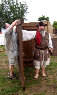 M.A. d'Dogge holding up a tavern wall section