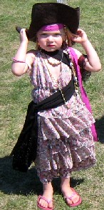 Pink pirate holding on to her hat