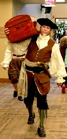 Gaston carrying a chest