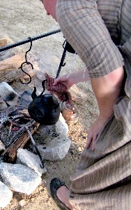 Chole removing the coffee from the fire
