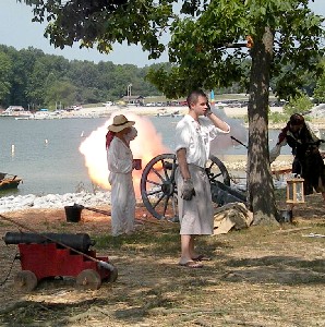 Guy on cell phone by cannons during battle