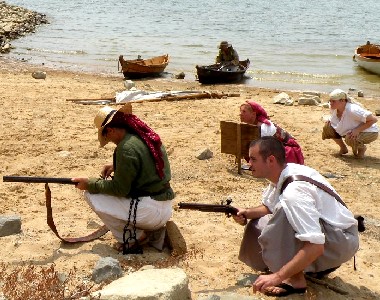 People crouched on beach ready to attack