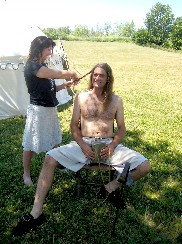 Tammi brading Mike's hair