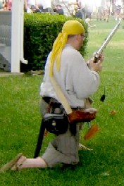 Dan Prepares His Rifle in Battle