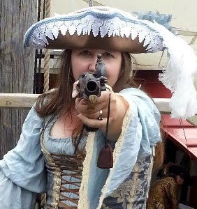 Trish pointing gun at camera