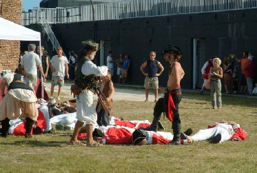 Pirates loot and pose with the dead