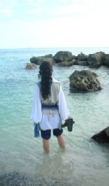 Mae looking forlornly out to sea