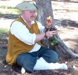 William chained to a tree eating an apple