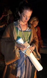 Mae showing the poster to the audience