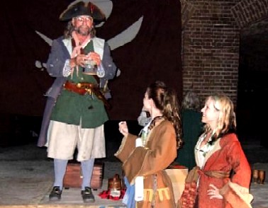 Captain Jim hands the auction item to Mae and Brig