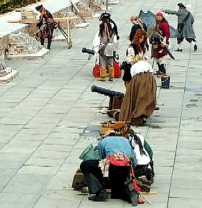 A look down the line of pirate cannon crews.