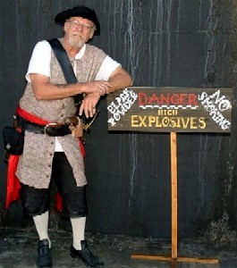 Pirate Harry leaning on the explosives sign