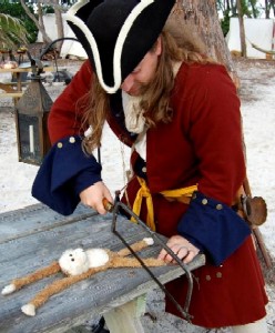 Michael Bagley sawing off Lob's legs with a bone saw