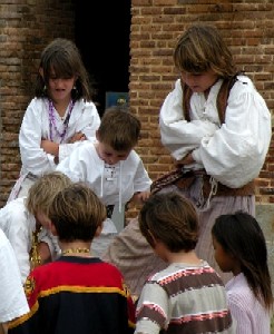 All the pirate kids look down at the fallen pirate