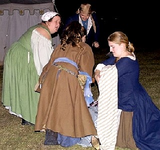 The women gather round Lilly