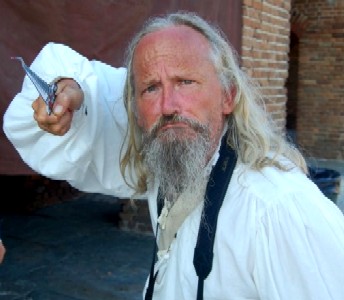 Papa Ratsey pointing a bent knife at you