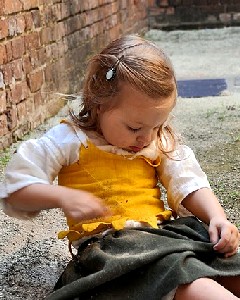Kiera cleaning sand off her dress