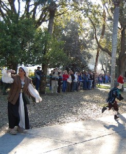 Women and children run away from the approaching bucaneers